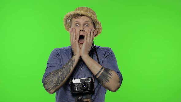 Portrait of Young Man Tourist Photographer Looking Shocked, Chroma Key