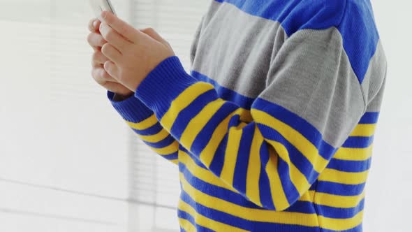 Boy dressed as executive using his mobile phone 4K