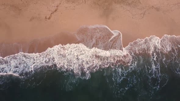 Top view of the sandy beach and stormy sea, foaming waves, beautiful views of the seascapes.