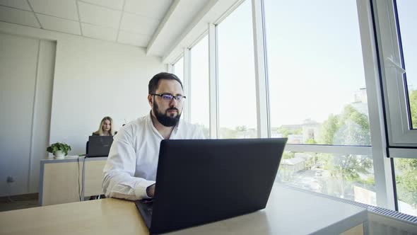Employee Looking at Computer Monitor During Working Day in Office