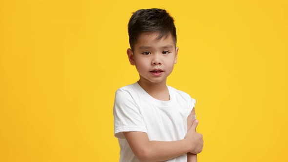 Vaccinated Korean Little Boy Showing Arm After Covid19 Vaccination Studio