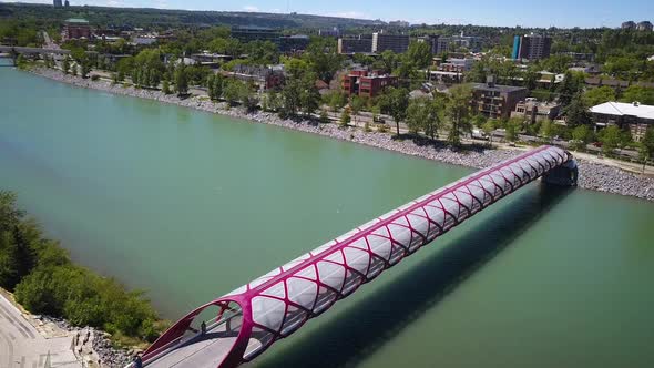 Aerial view of a beautiful and modern pedestrian bridge over a river.