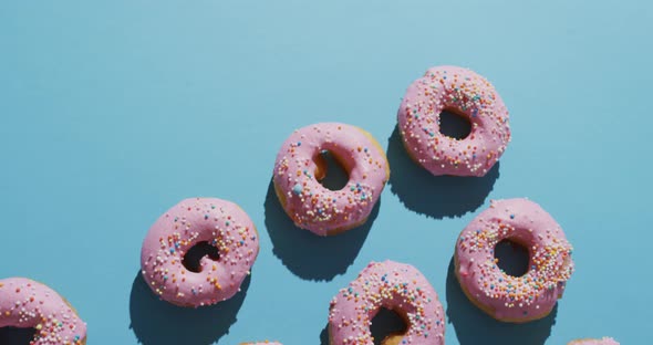 Video of donuts with icing on blue background