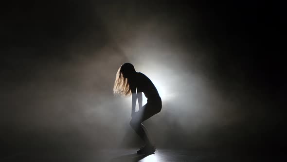 Sexy Girl Dancing in a Smoky Studio Twerk Dance. Silhouette