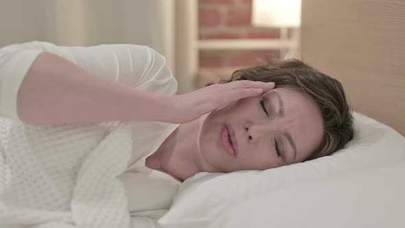 Sleeping Old Woman Having Headache in Bed 