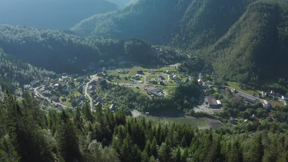 Overview of small Norwegian village Tveitane in Vaksdal inside forest - Aerial with parallax effect