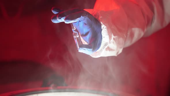 Doctor epidemiologist takes coronavirus sample in laboratory from the cryogenic chamber