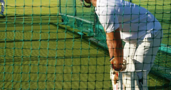 Cricket players practicing in the nets during a practice session