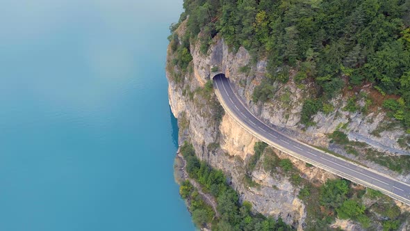 Mountain Road with Blue Lake Below and Tunnel