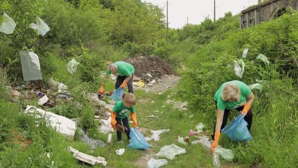 Team of Nature Activists in Eco T-shirts Picking Up Plastic Trash in Park. Recycle, Earth Pollution