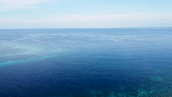 Aerial drone rising over stunning coral reef ecosystem on the coral triangle overlooking pristine bl