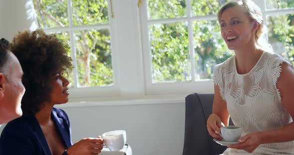 Friends interacting while having coffee