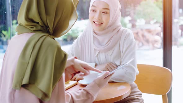 Young Asian Muslim Women Enjoying A Relaxing Moment in the Coffeeshop 03