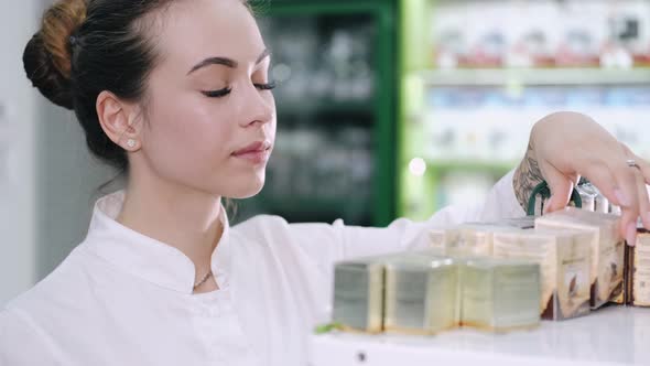 A Female Pharmacist Is Looking at Some Products on the Shelf
