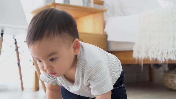 Baby Boy Crawling on the Floor in Living Room Indoors