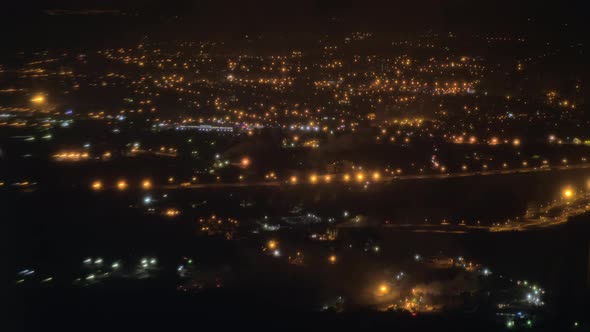 Flying by plane over Paris illuminated at night, France