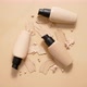 Bottles of Makeup Foundation and Samples on Beige Background - VideoHive Item for Sale