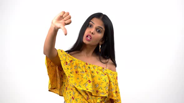 Frustrated Indian girl showing thumbs down