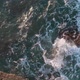 The waves crash against the rocky sea coast. Top view, water mixed with foam. - VideoHive Item for Sale