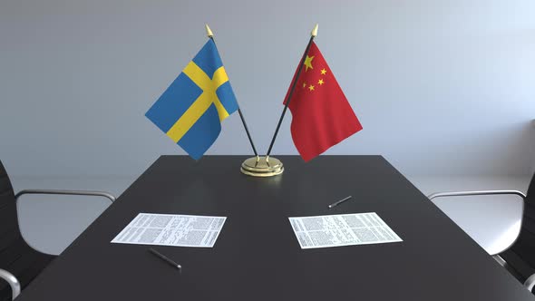 Flags of Sweden and China on the Table