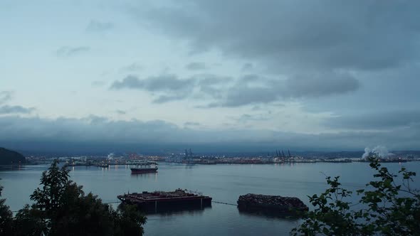 Time Lapse of a cloudy sunrise over the Port of Tacoma, Washington. Seen from Browns Point, rolling
