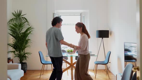 Couple dancing in living room