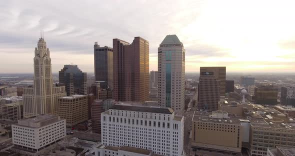 wide revealing drone shot of downtown Columbus Ohio with sunsetting