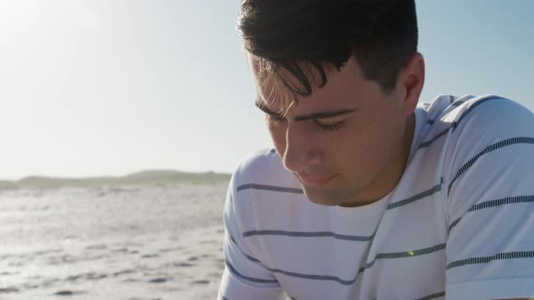 Man crouching on the beach