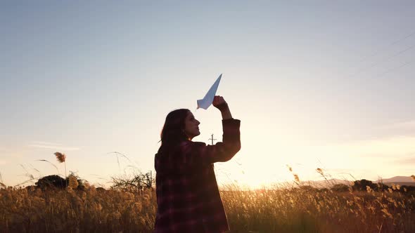 Silhouette of Girl with Paper Plane