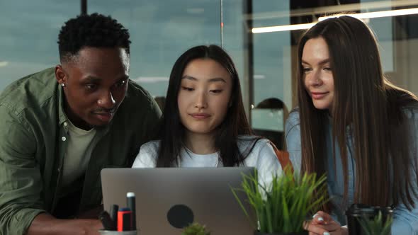 Multiethnic Group of Ambitious Employees Cooperating in Office Discussing Future Startup Plans