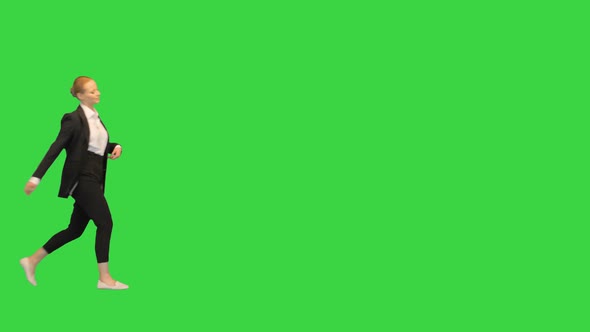 Young Attractive Blonde Businesswoman Walking By in a Lax Way on a Green Screen Chroma Key