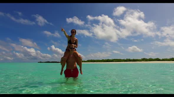 Boy and girl tan on paradise bay beach holiday by transparent lagoon and white sand background of th