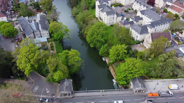 Top down aerial over the river Avon in Bath, a variety of residential buildings and communal areas a