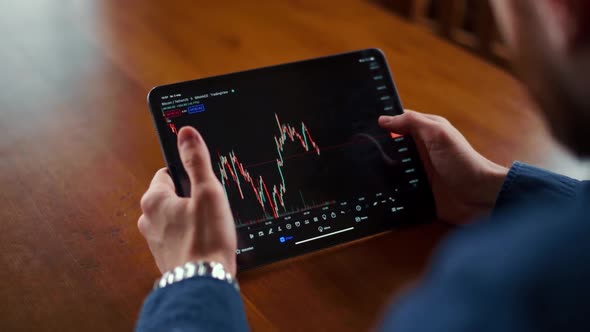 Businessman checking bitcoin price chart on digital exchange on mobile phone screen, cryptocurrency