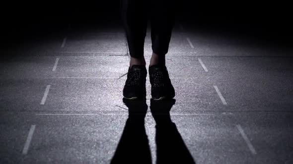 Person Jumps on the Jumping Rope, Feet in Silhouette, Front View, Slow Motion