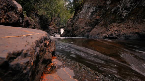 Cascading river flowing through rocky gorge in the woods at Cascade River State Park in Minnesota