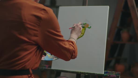 Female Artist Drawing Colorful Picture on Easel