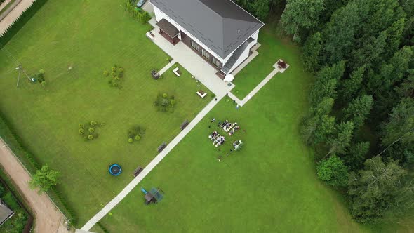 Top View of the Wedding Venue in a Green Field and a House in the Forest. Wedding Ceremony with