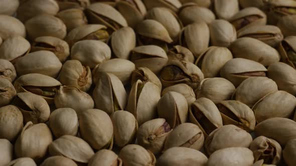 Cinematic, rotating shot of pistachios on a white surface - PISTACHIOS 014