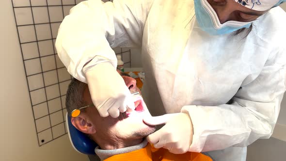 Man Undergoing Dental Cleaning at the Dentist