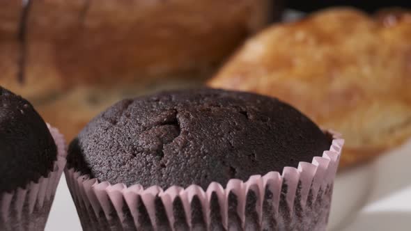 Various types of cakes on white plate rotating in front of camera, Close-up rotates view of Sweets