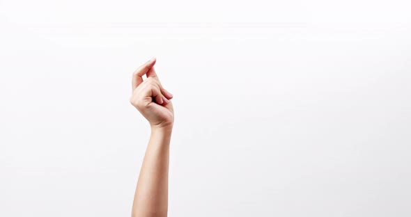 Close up of Woman's hand snapping her finger doing the hand gesture isolated on a white studio backg