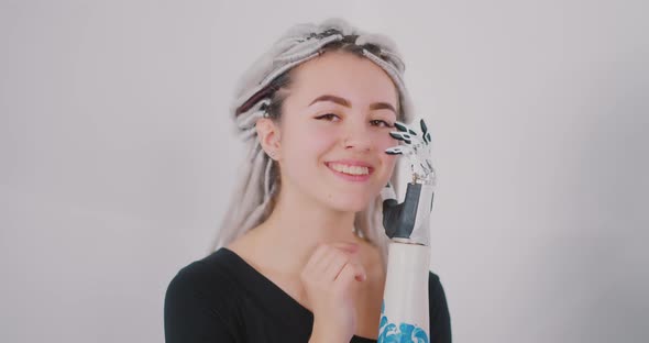 The girl with the bionics hand is smiling Bionics Cybernetic Robotic-arm Hand prosthesis