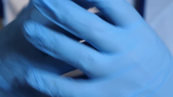 Doctor Put on Blue Latex Gloves