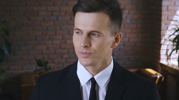 Portrait of Smiling Businessman in a Modern Office