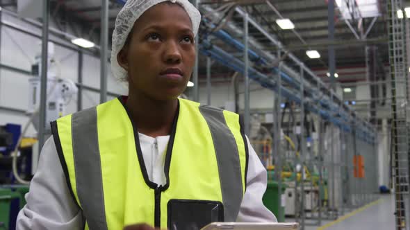 Warehouse female worker using digital tablet