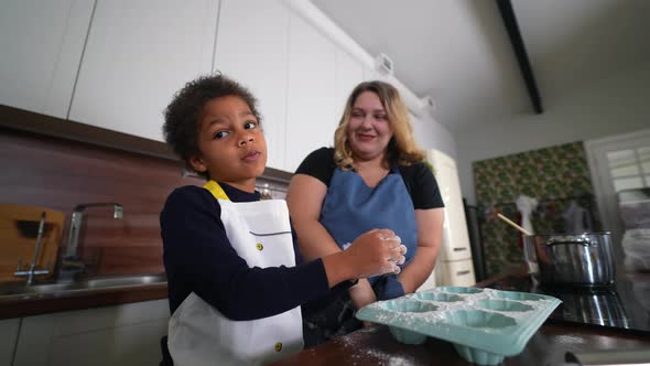 Happy Mommy and Daughter Girl Having Fun While Cooking in Kitchen