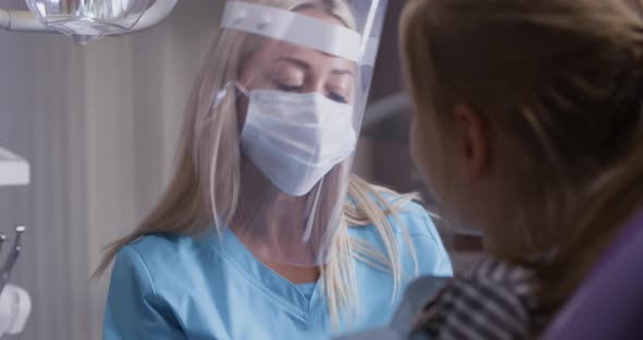 Dental Specialist Working with Little Girl