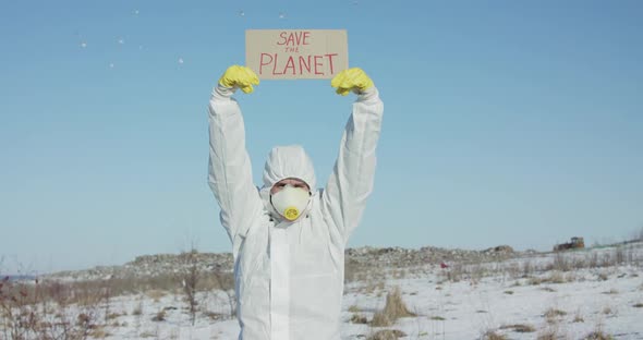 Man Wore in White Full Cover Suit Raises Protest Sign Save the Planet in Winter