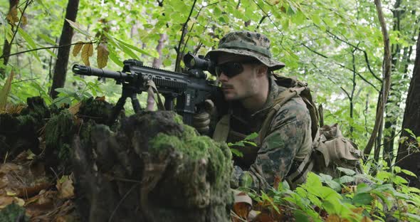 Fully Equipped Rifle Soldier Wearing Camouflage Uniform Attacking Enemy Rifle in Firing Position in